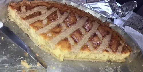 A lattice-topped baked tart on a metal tray