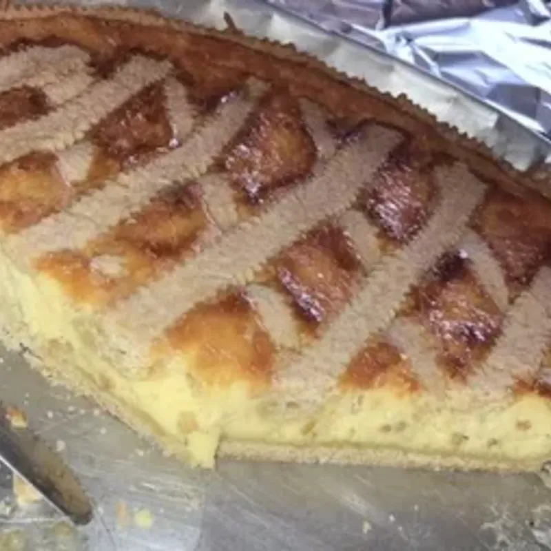 A lattice-topped baked tart on a metal tray